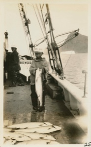 Image of Eskimo [Inuk] Boy holding salmon, on the Bowdoin